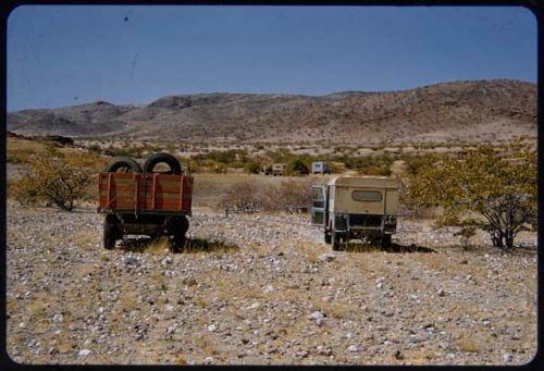 Marshall and Visser expedition trucks, with hills on the west side of the Baynes Mountains in the background