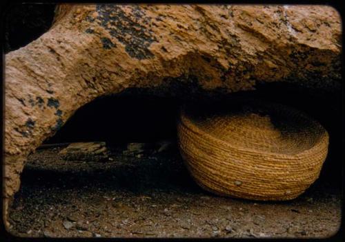 Basket on the ground in the mouth of a cave