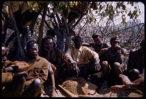 Veripaka sitting with members of his council, a pile of tobacco on the ground near them