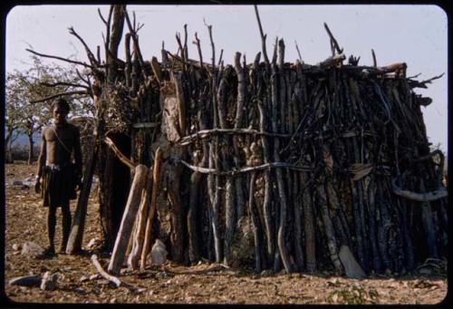 Man standing in front of a storehouse