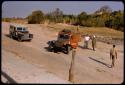 Expedition trucks (Land Rover and Dodge) waiting to cross the Kunene River on a pont