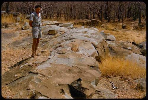 Mr. Prinsloo standing on rocks with petroglyphs on his farm