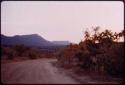 Road, with a mesa-like hill in the distance