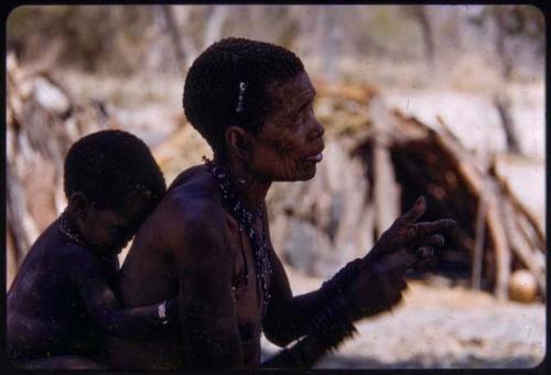 Hambia's wife, with a child on her back, profile