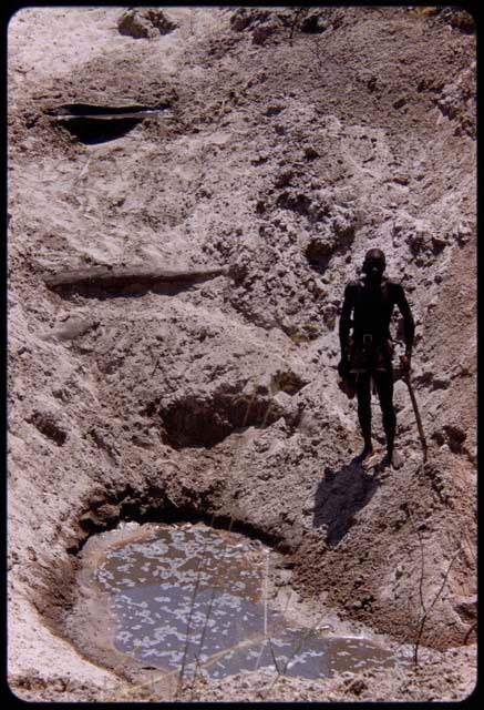 Man standing next to Hambia's waterhole