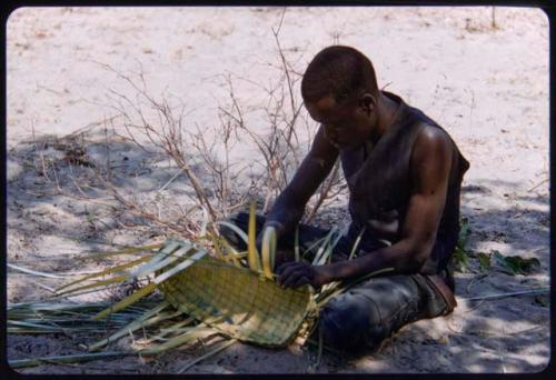 Man from Shikongo's group making a basket