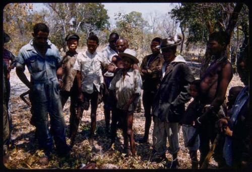 People standing around a goat carcass in the expedition camp at Hambia's living place