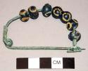 Bronze fibula with glass eye-beads on bow