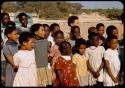 Children standing in line and singing for Colonel Hoogenhout (the South West Africa administrator) at a school, close-up