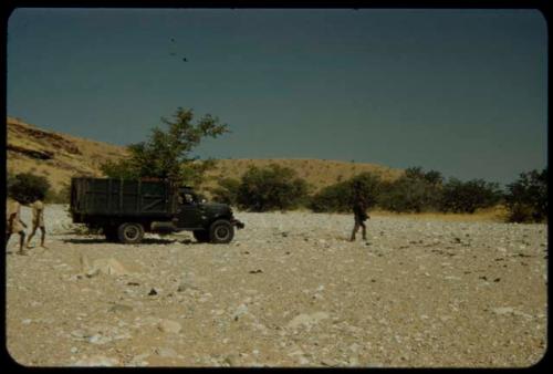 Expedition truck crossing a dry river bed