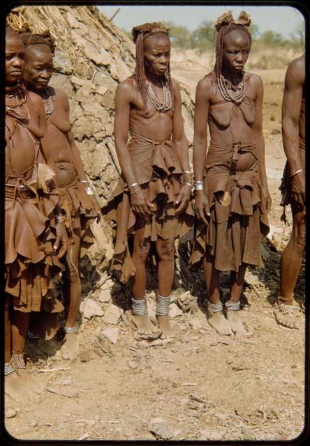 Three women standing in line to have their photographs taken