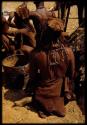 Woman holding an oil tin used for carrying water