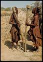 Two women grinding corn