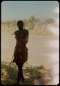 Headman of a village near the Gomatum River standing, leaning on a stick