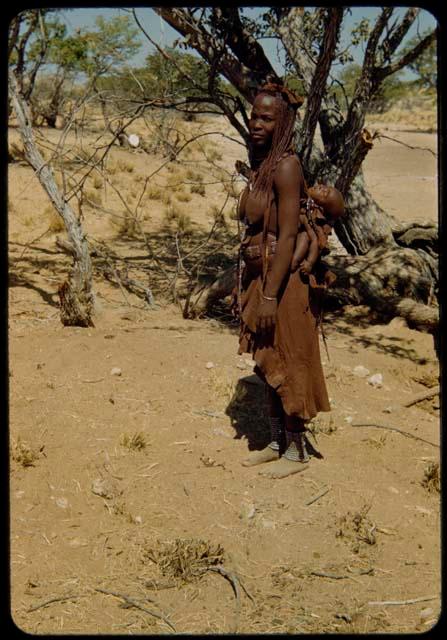 Woman carrying a baby on her back, profile