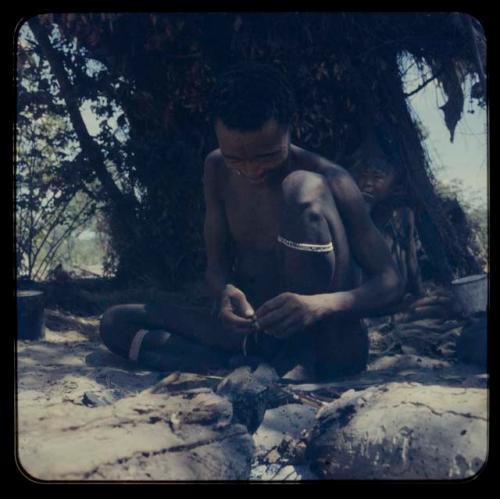 Bo Jo sitting and poisoning an arrow