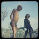 Boy bathing, helped by a friend