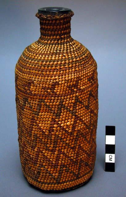 Glass bottle covered with fine twined basketry