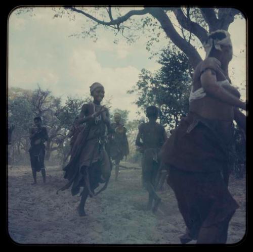 Girls playing N!owa T’ama (melon tossing game) / tamah n!o’an (ball game)