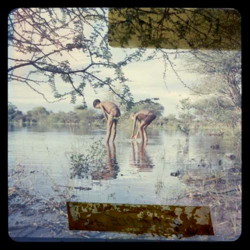 Two boys standing in the water