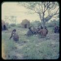 Group of people sitting, with skerms in the background