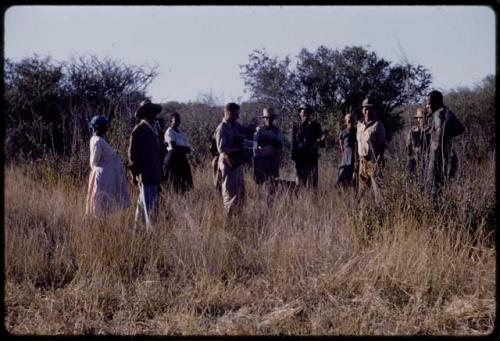 Group of people standing in the grass