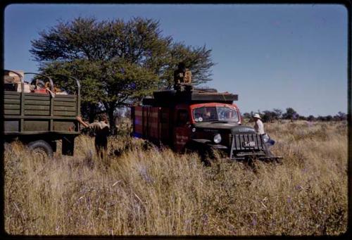 Expedition members on trucks