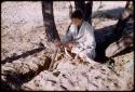 Elizabeth Marshall Thomas holding a piece of quiver root