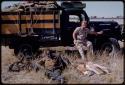 Theunis Berger and Simon Molamo sitting in front of truck with a hunting kill