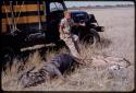 Theunis Berger sitting on a truck with hunting kills