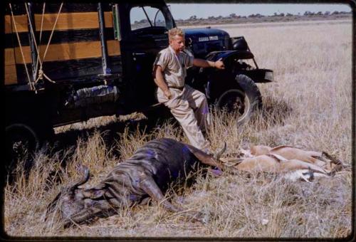 Theunis Berger sitting on a truck with hunting kills