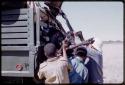 Expedition members hoisting a wildebeest into a truck