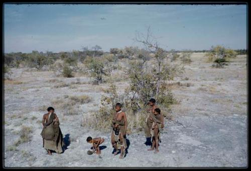 Water: //Kushay, !Ungka, //Khuga and children standing near the Gautscha waterhole