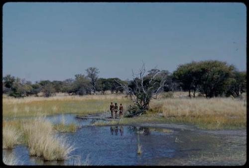 Water Hole: Men walking beside a vley (small pan) near Gautscha