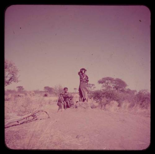 Children, Groups, Play: Girls standing and sitting on an anthill