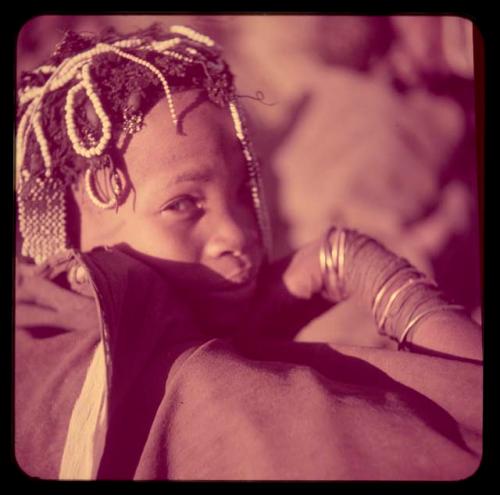 Children, Portraits: Girl wearing white beaded ornaments that lie across the top of her head and hang down