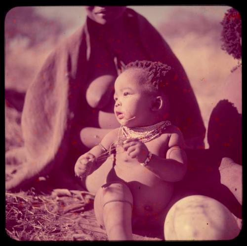 Children, Portraits: Bau's baby sitting next to an ostrich eggshell