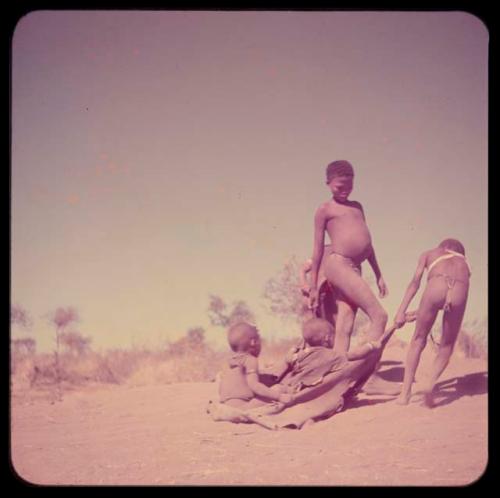 Children, Toys, Playthings: Boy pulling two children on a kaross