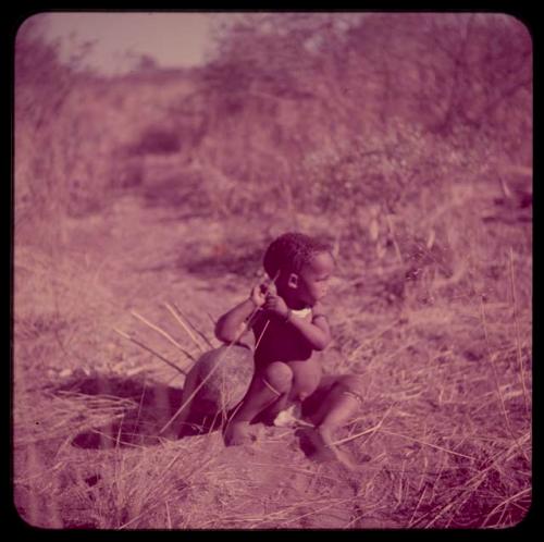 Children, Music: Little girl sitting and holding a //guashi