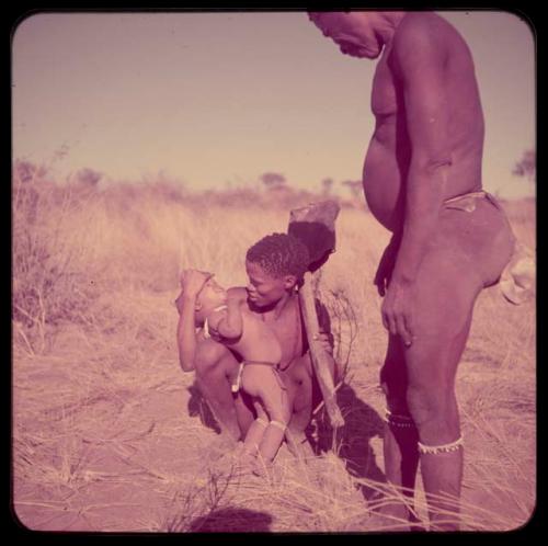 Children, Music: //Ao holding his daughter and a one-stringed "violin," with "Old Gau" standing next to him