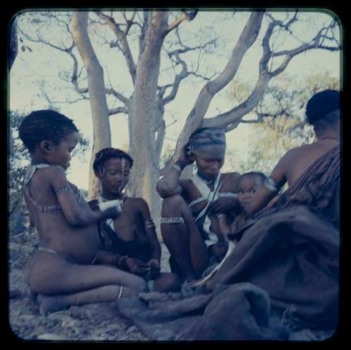 Group of women and children sitting