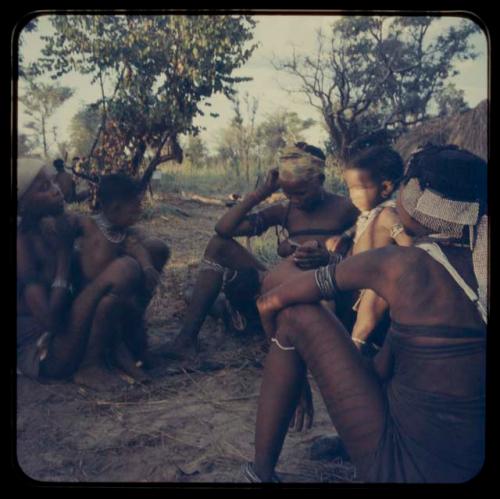 Group of women and children sitting