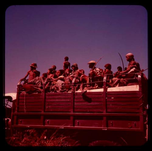 Group of people riding in a truck on the way from !O to !Nama