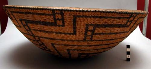 Bowl-shaped basket, coiled. Geometric designs.