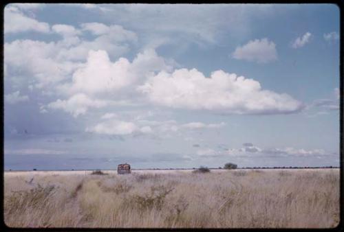 Expedition truck driving, in the distance