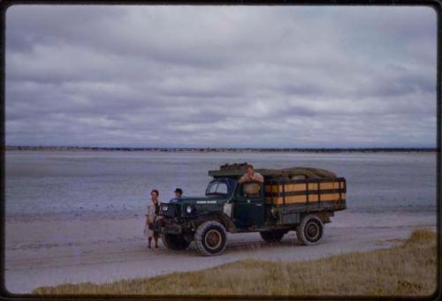 Lorna Marshall and Laurence Marshall standing by expedition truck