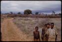 Group of boys standing by a road