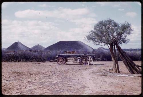 Cart, village in background