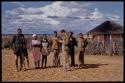 William Donnellan standing in front of a group of people standing in a line