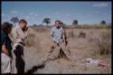 William Donnellan, Elizabeth Marshall Thomas, and Dabe standing by a springbok carcass, Theunis Berger taking a picture